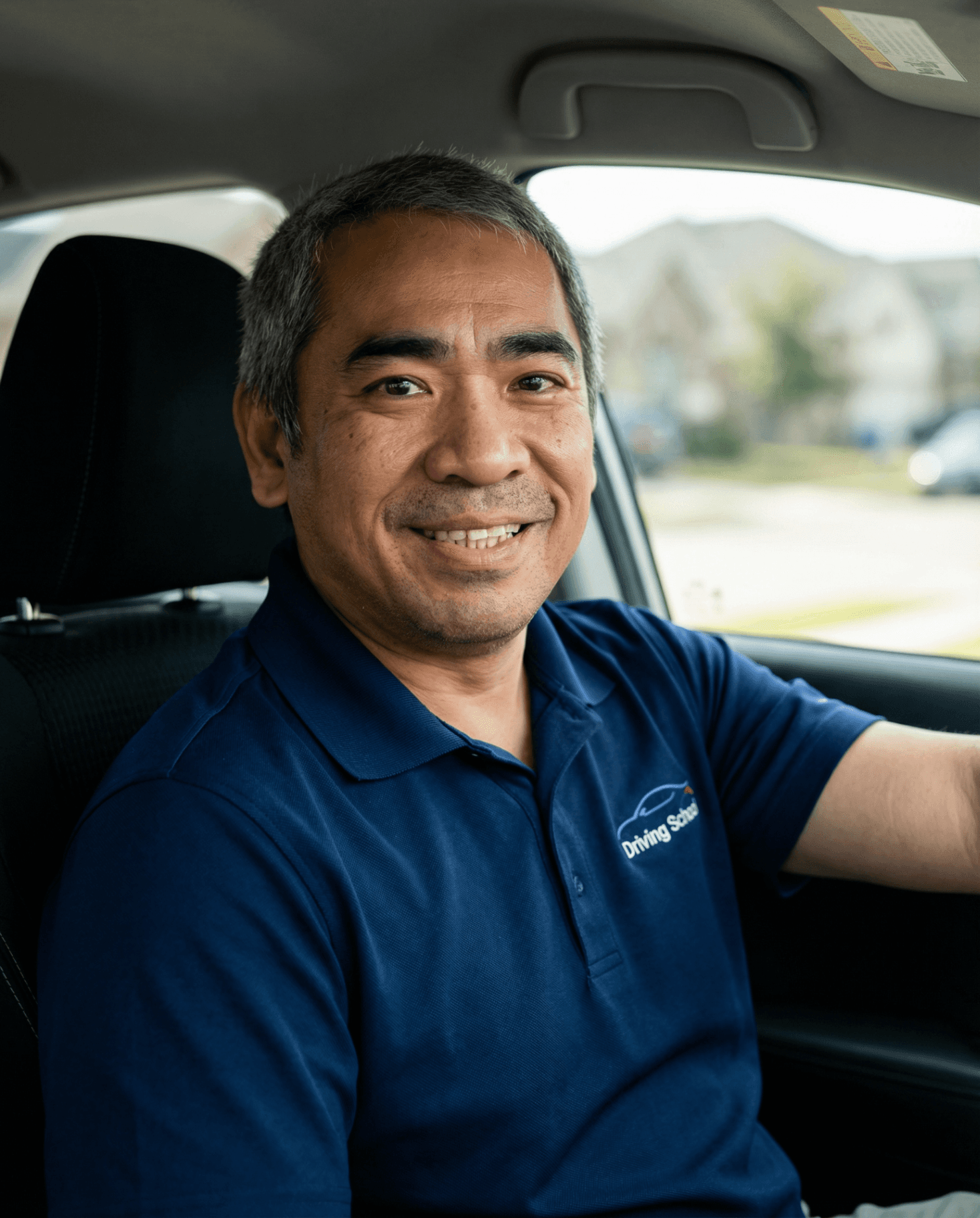 Roy Alcazar seated in a driver training vehicle